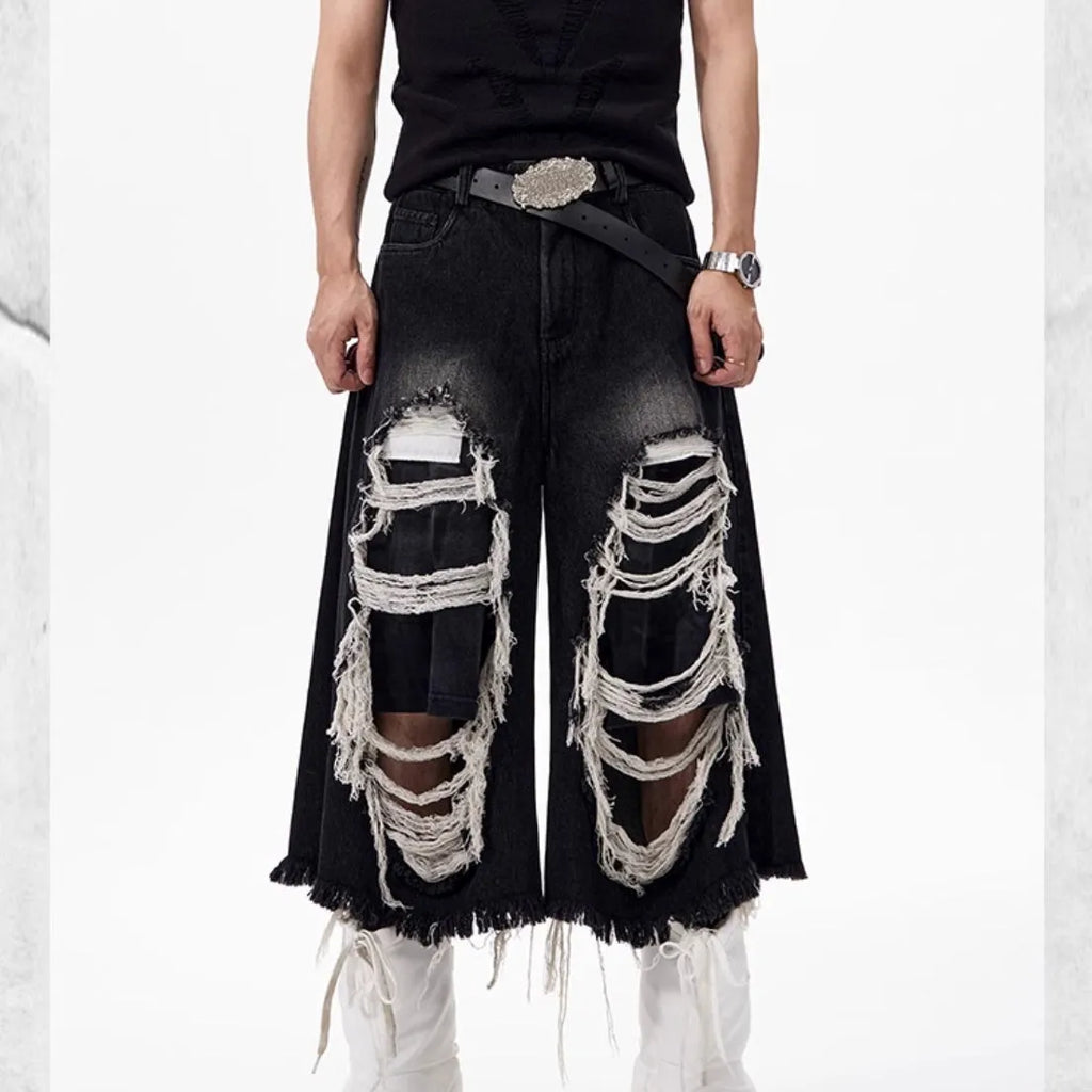 Black women's cropped wide-leg jeans with ripped patch detail and a mid-high waist
