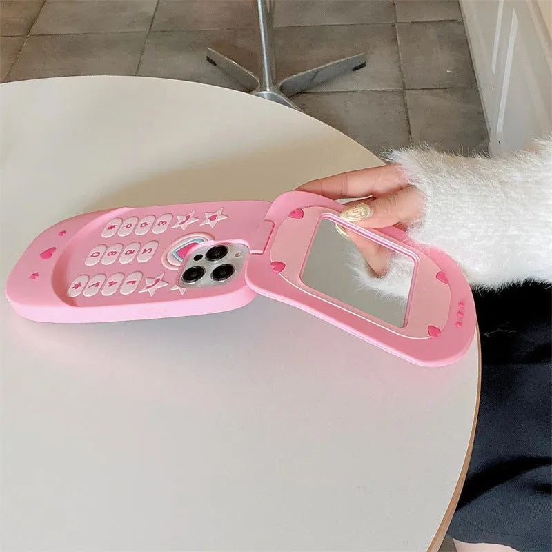 Pink silicone iPhone case with a flip-open mirror cover on a table.