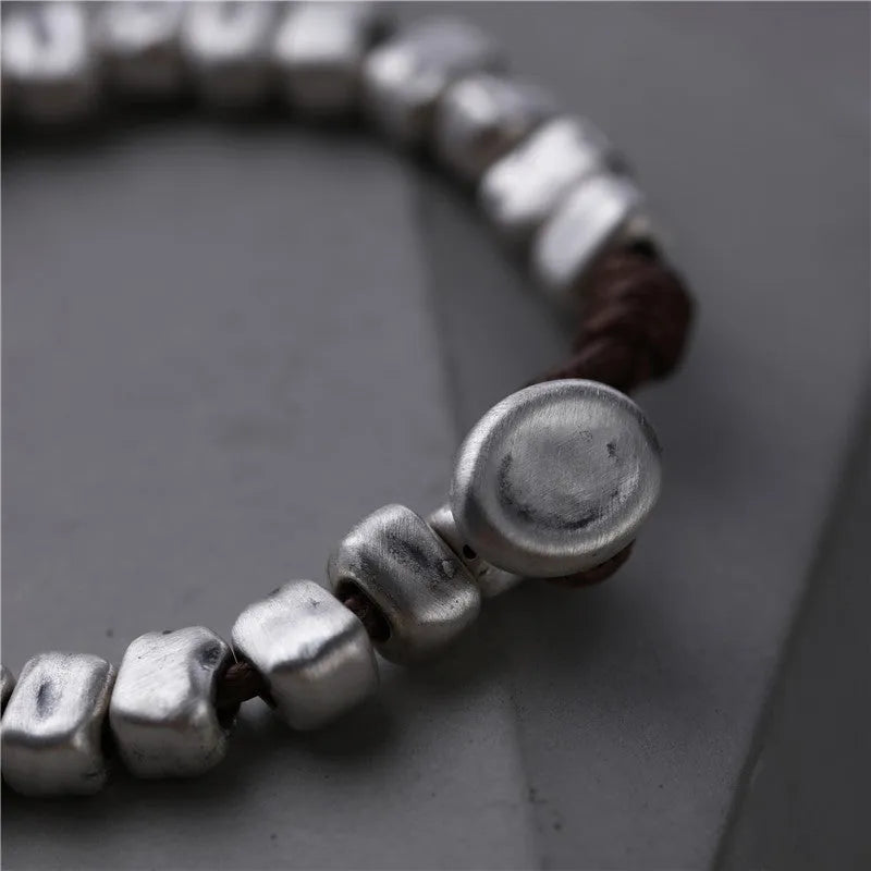 Handmade women's bracelet with irregular silver squares on wooden beads and elastic band