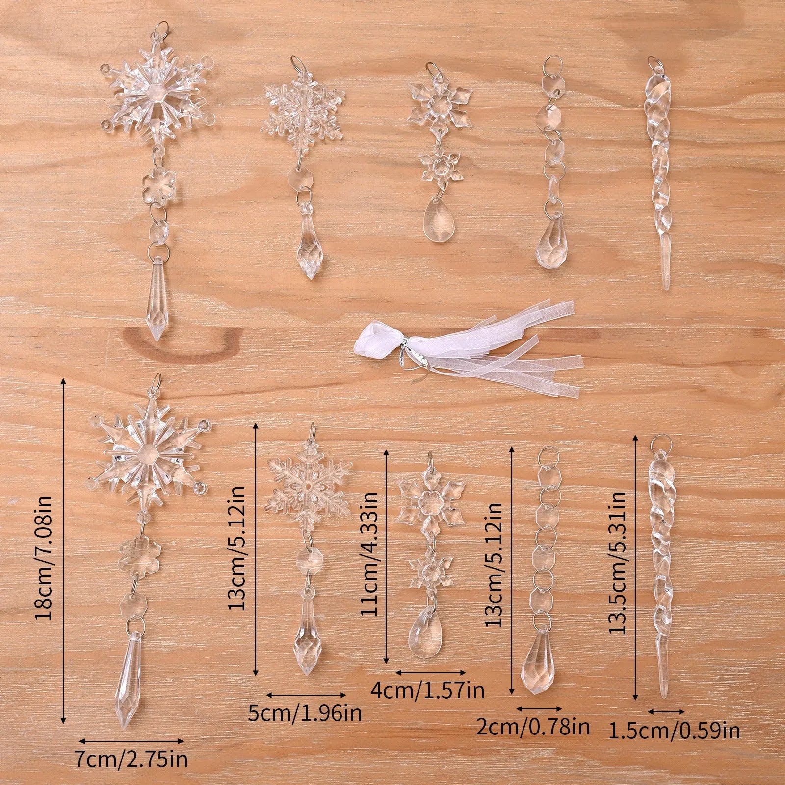 Set of ten clear acrylic icicle and snowflake Christmas ornaments with white hanging ribbons.