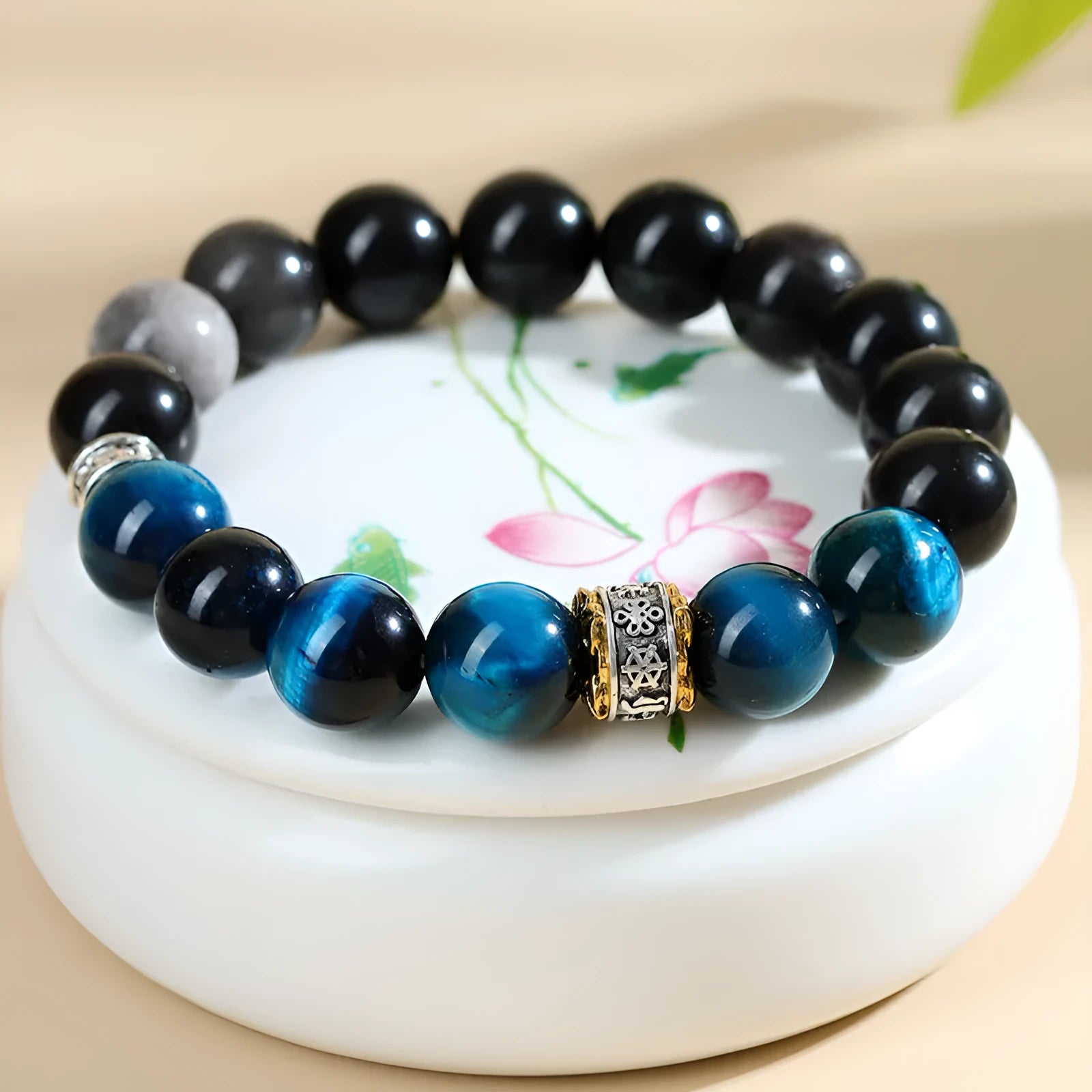 Handmade geometric Peacock Blue Tigereye stone bracelet with round beads on a wrist.