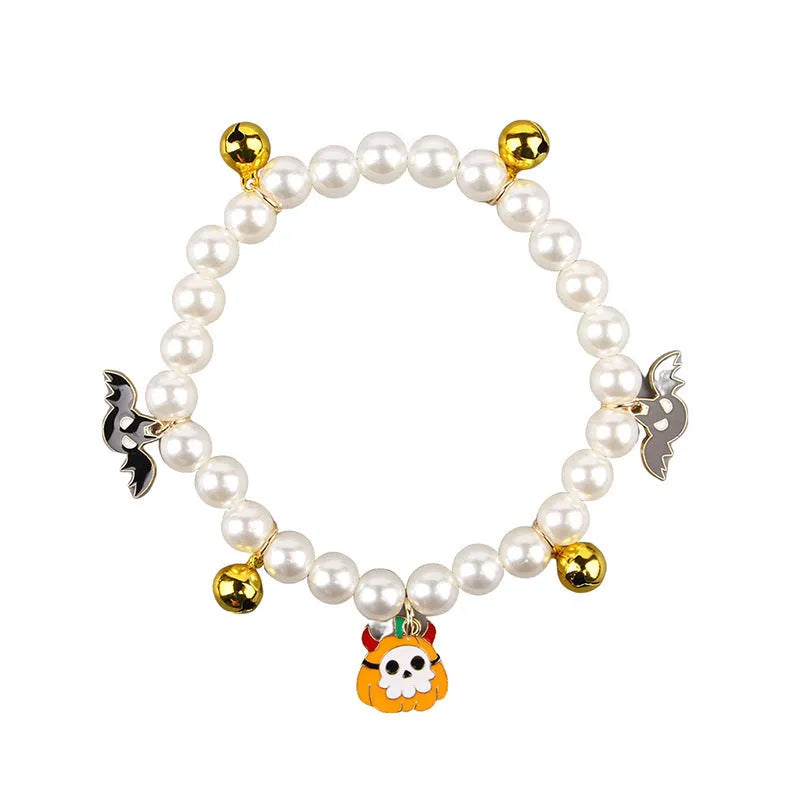 Simulated pearl Halloween cat collar with a choice of purple ghost, skull, or smiling pumpkin charm.