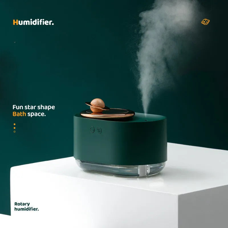 Green rotating planet-shaped USB humidifier with night light on a wooden surface
