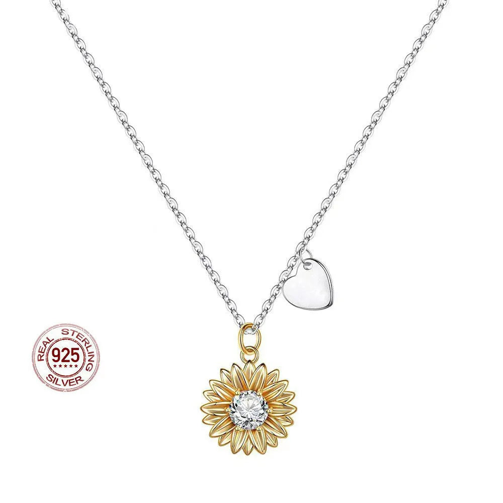 Close-up of a sterling silver sunflower necklace with geometric daisy pendant on an adjustable cross chain.