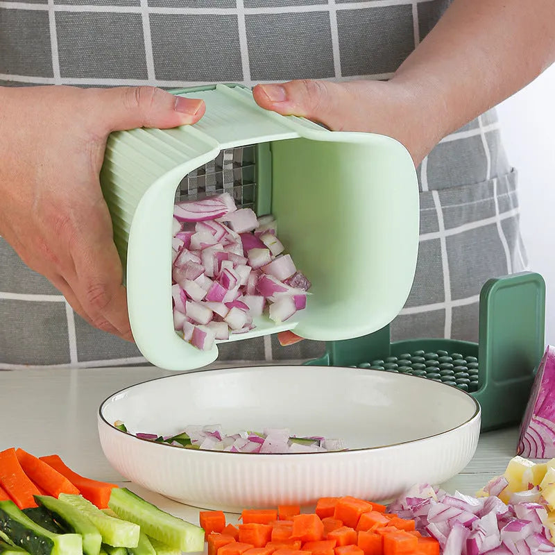 Green hand-operated vegetable chopper with stainless steel blades for slicing onions, potatoes, radishes and cucumbers