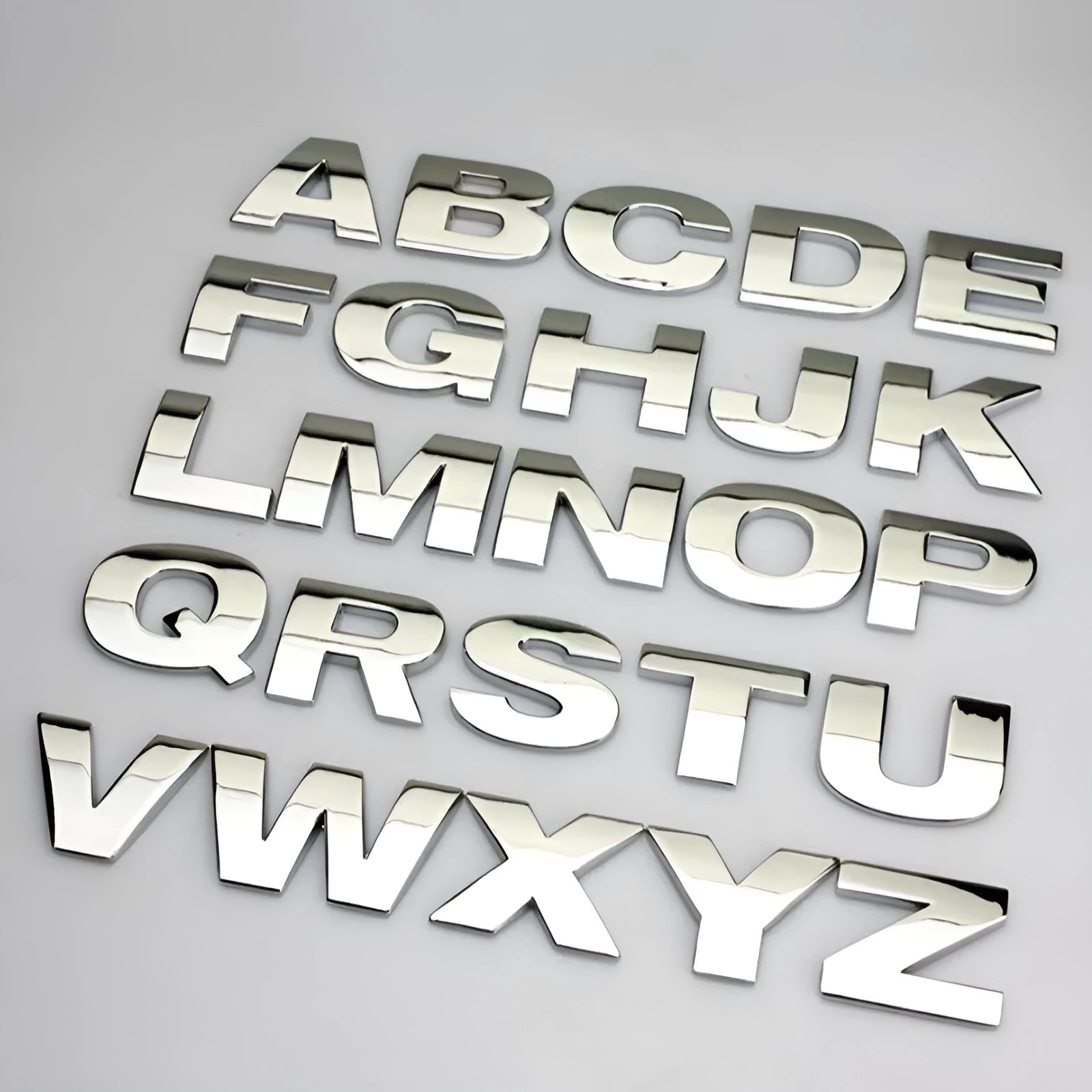 Zinc alloy 3D raised letter car sticker for bumper customisation in black or silver.