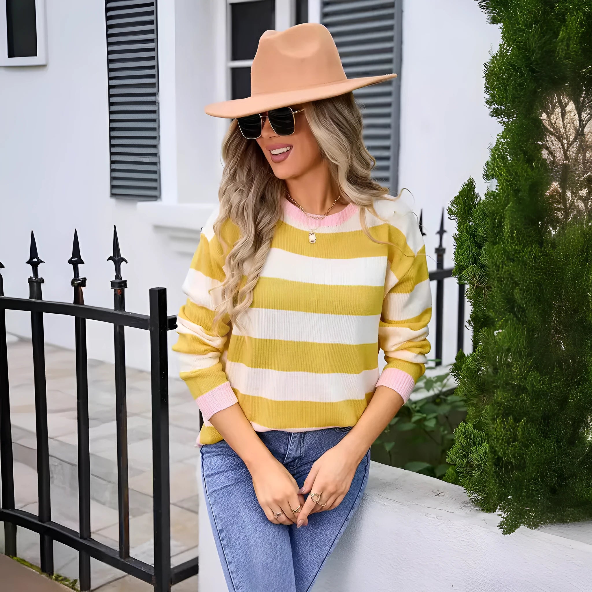 Women's loose blue acrylic sweater with striped pattern and round neck.