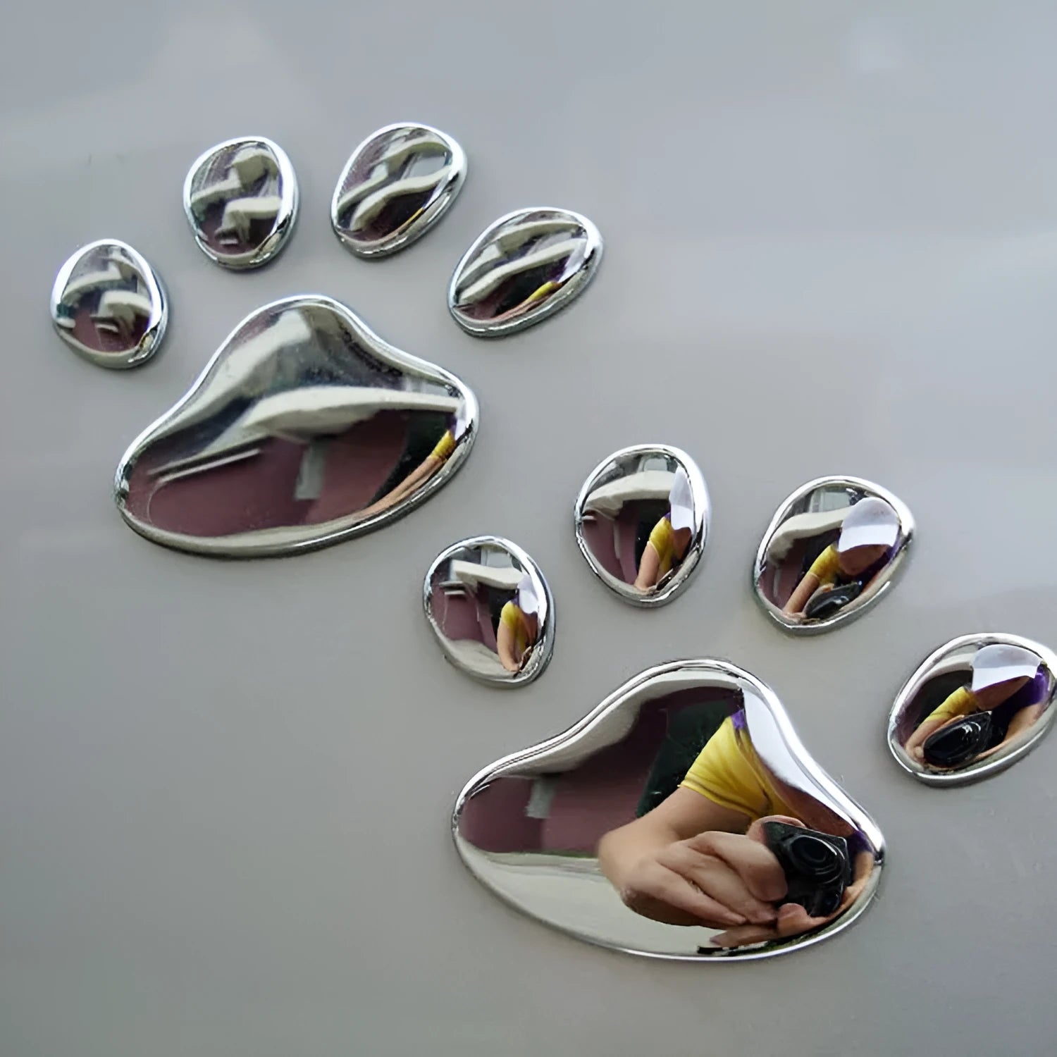 PVC car sticker with hand-shaped brush design showing dog footprint pattern in choice of colours