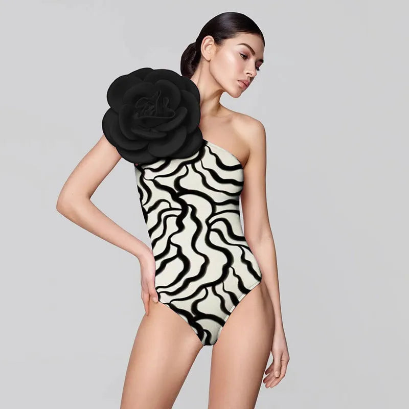 Women's solid colour one-piece swimsuit with three-dimensional flower design for swimming.