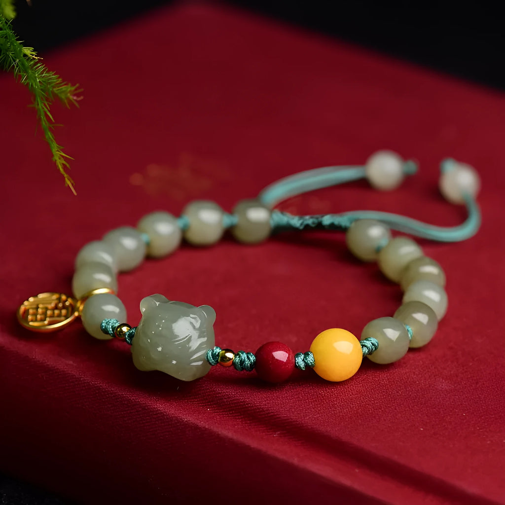 Natural Hetian Jade bracelet with cinnabar and beeswax beads, animal zodiac motifs, and sequin details on a string