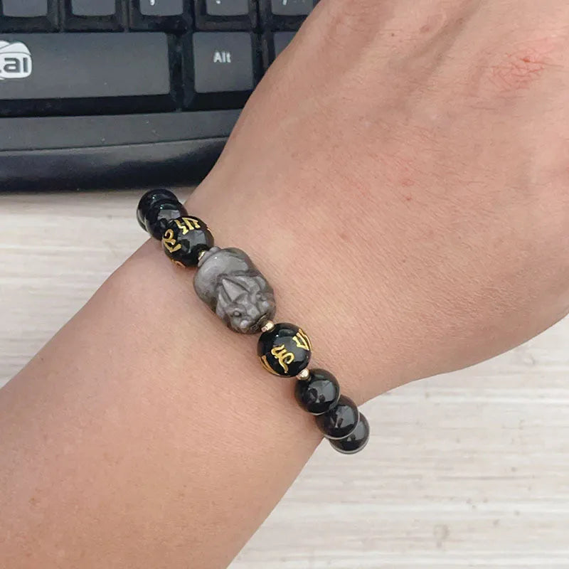 Men's silver stone beaded bracelet with zodiac and Chinese proverb charms on a wrist.