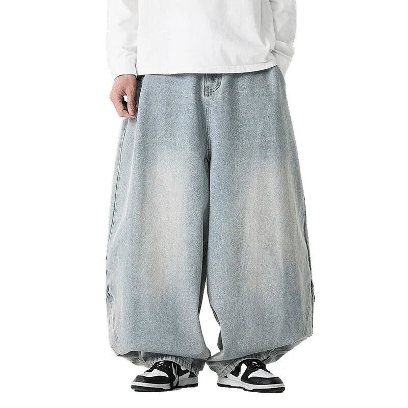 Men's plus size light blue baggy wide-leg jeans on a hanger, showing straight leg and low waist.