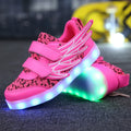 Children's plum red and white LED light-up sneakers with USB charging port visible.