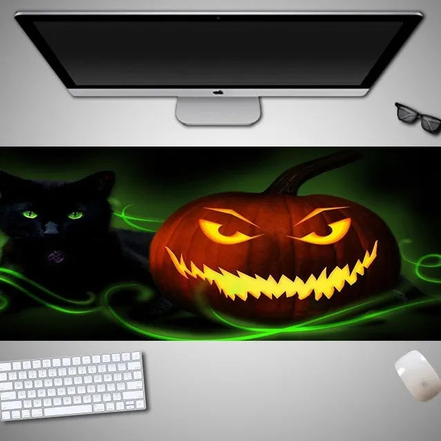 Oversized Halloween-themed mouse pad with non-slip rubber base on a desk.