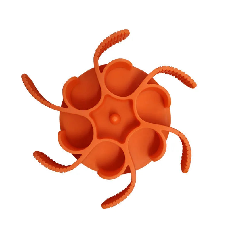 Red silicone dog slow feeder insert with spiral design and suction cups on a white background.