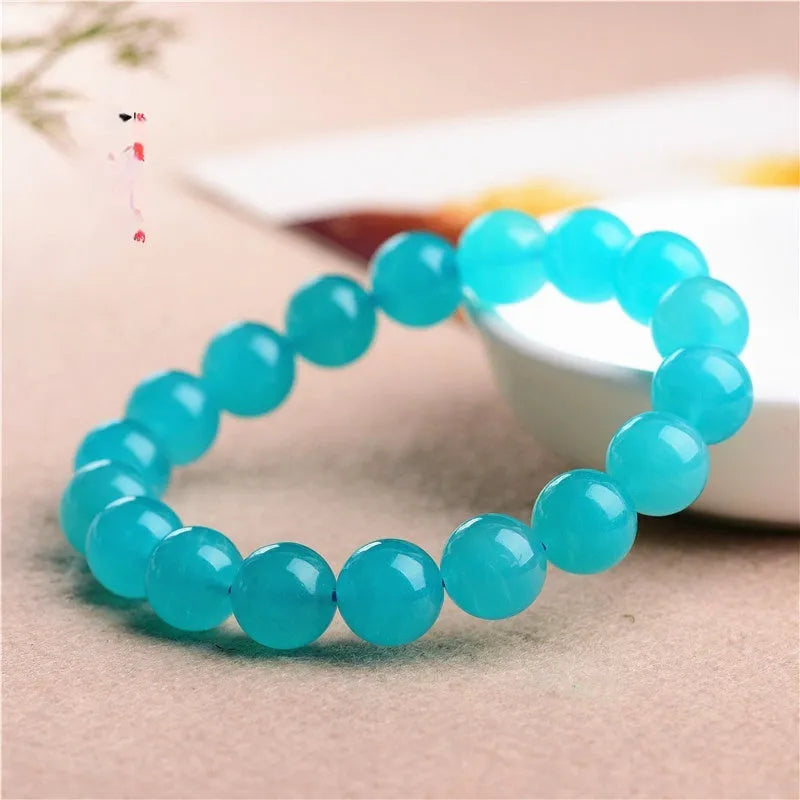 Natural blue-green Amazonite 7A grade scattered beads bracelet on a white background.