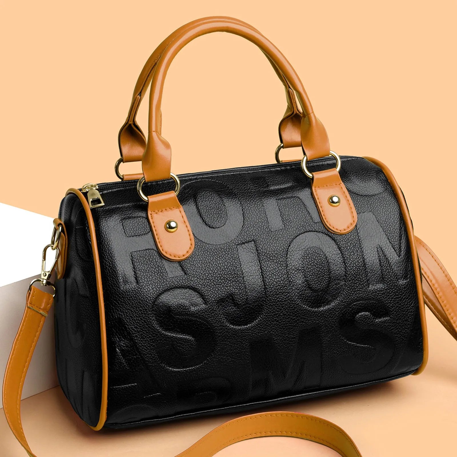Cylindrical brown PU crossbody bag with three shoulder straps showing textured interior lining
