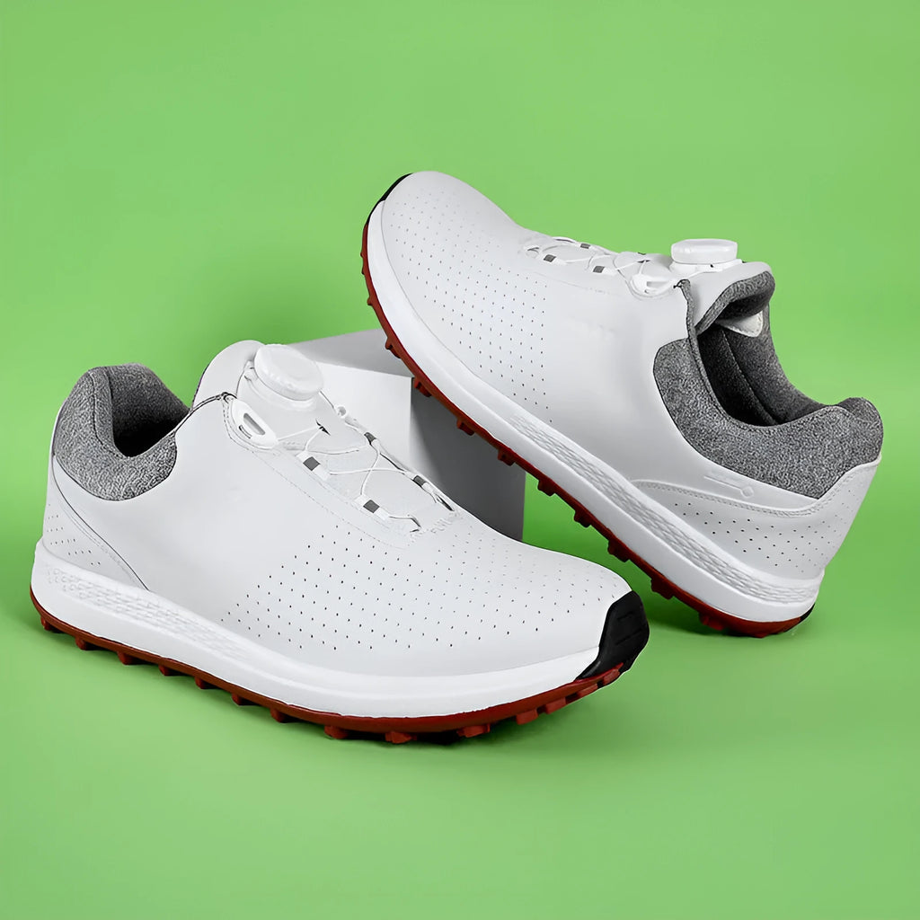 Men's low top white golf sneakers with breathable holes and a broken nail pattern sole.