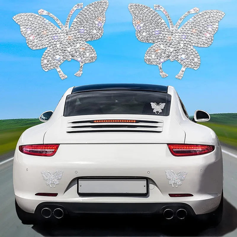 Close-up of a diamond-encrusted bear paw and butterfly design on a 7x6cm glass car sticker.