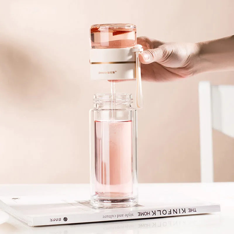 Double wall glass tea infusion bottle with stainless steel filter and rope handle in various colours.