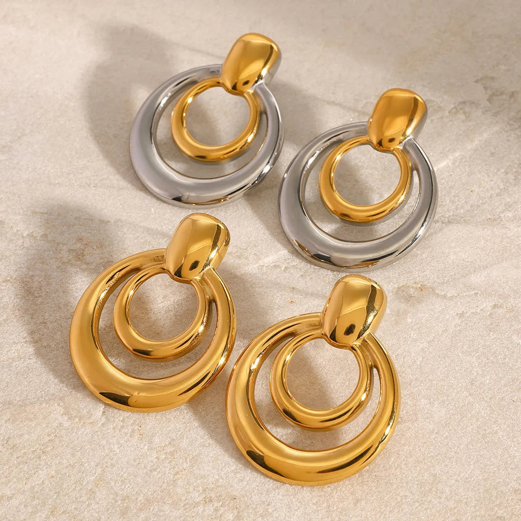 Round golden hollow stud earrings with double layer construction and 18K gold plating