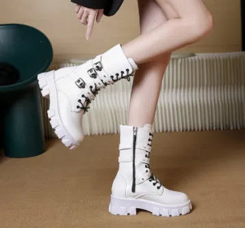 A pair of women's black mid-calf knight boots with a side zip and a large metal buckle strap.