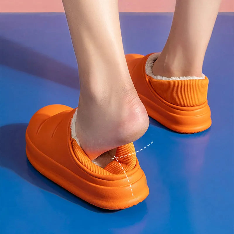 A pair of waterproof EVA couple slippers in green with a plush lining and non-slip sole.
