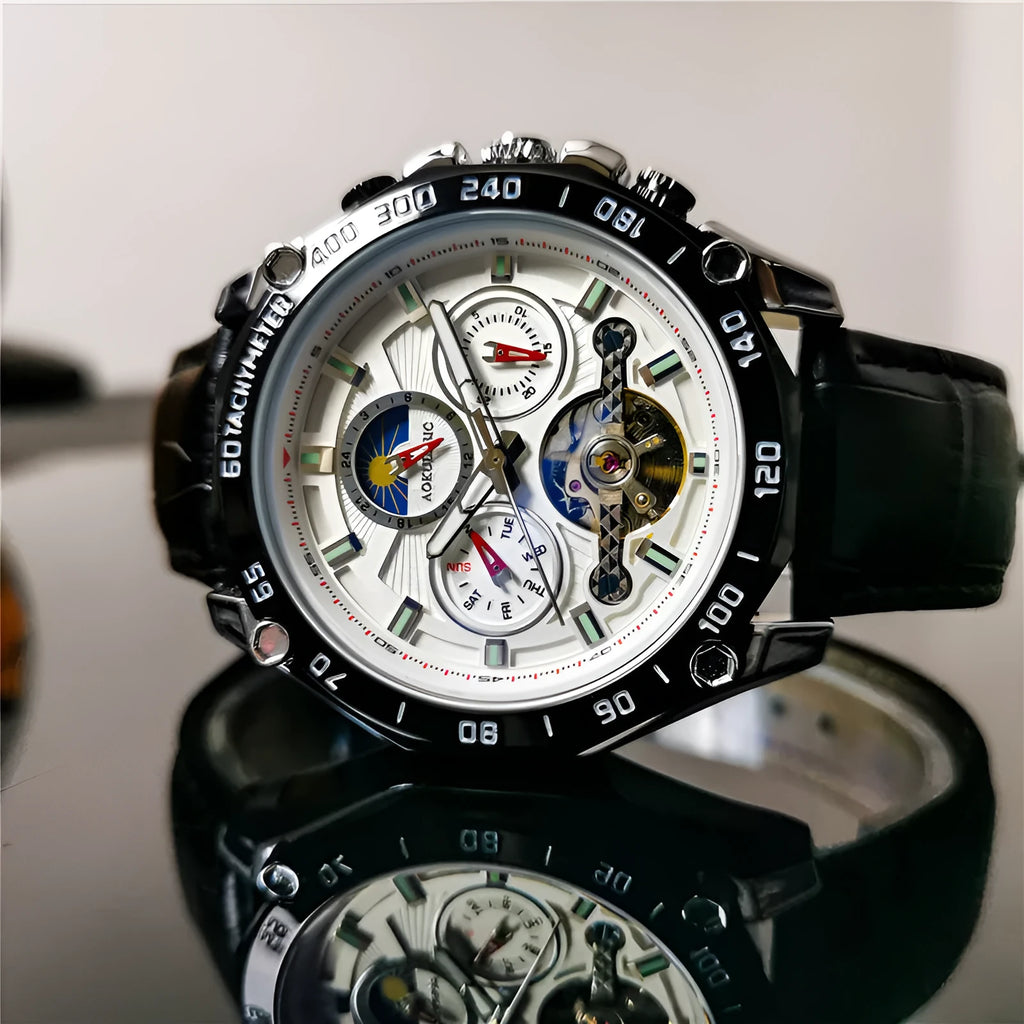 Men's automatic mechanical watch on wrist showing silver metal case and black dial.