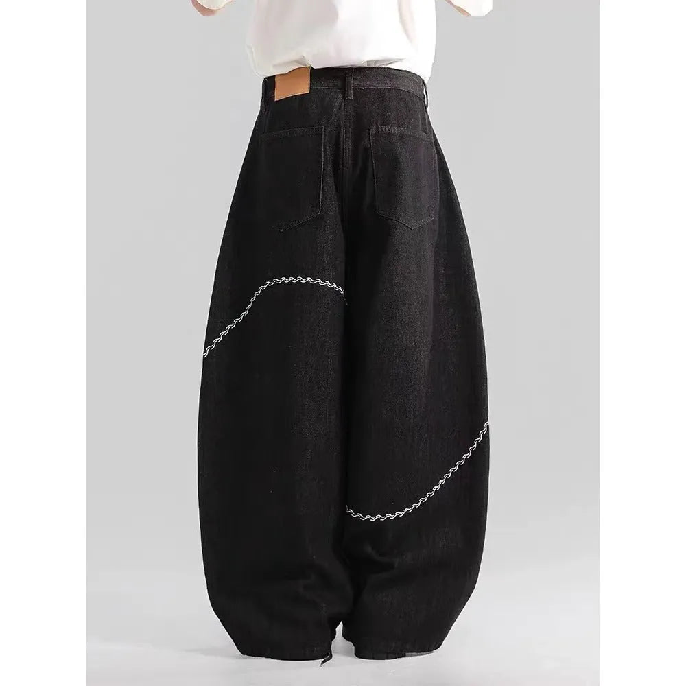 Black straight-leg denim trousers with mid-waist design and zip placket closure