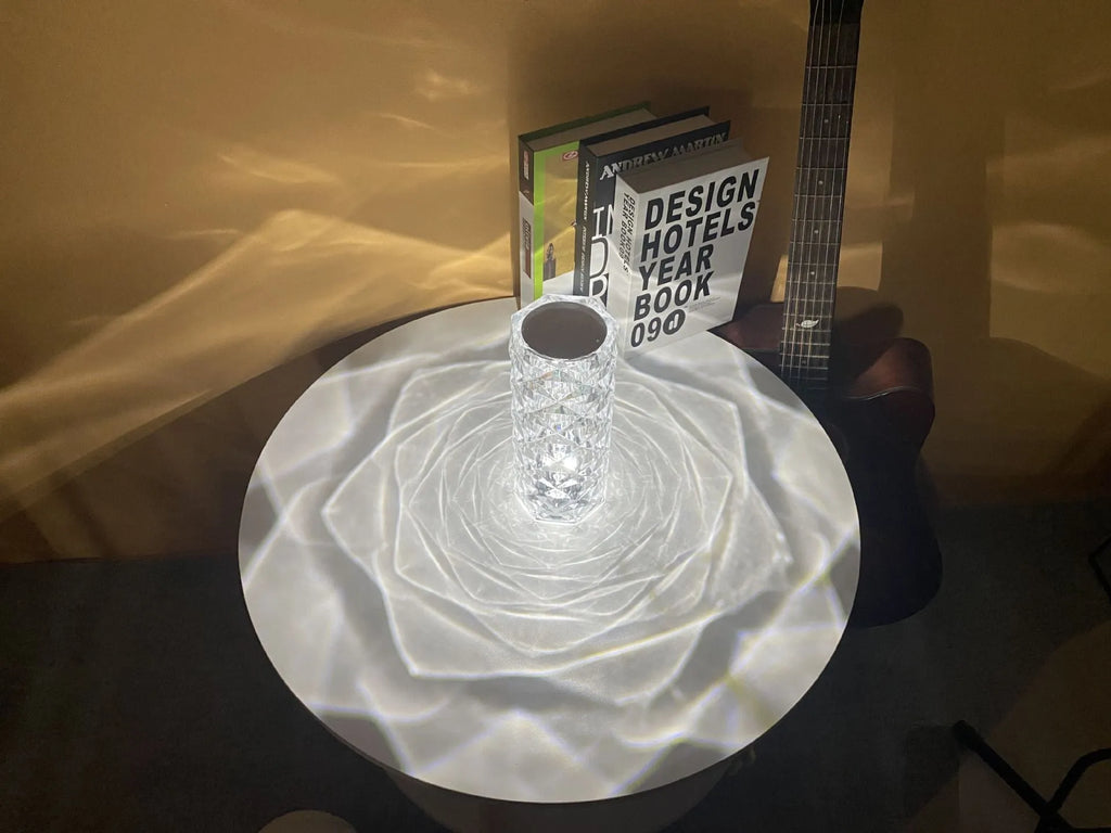 LED rose diamond shaped table lamp with acrylic construction and three-tone lighting on a wooden surface.