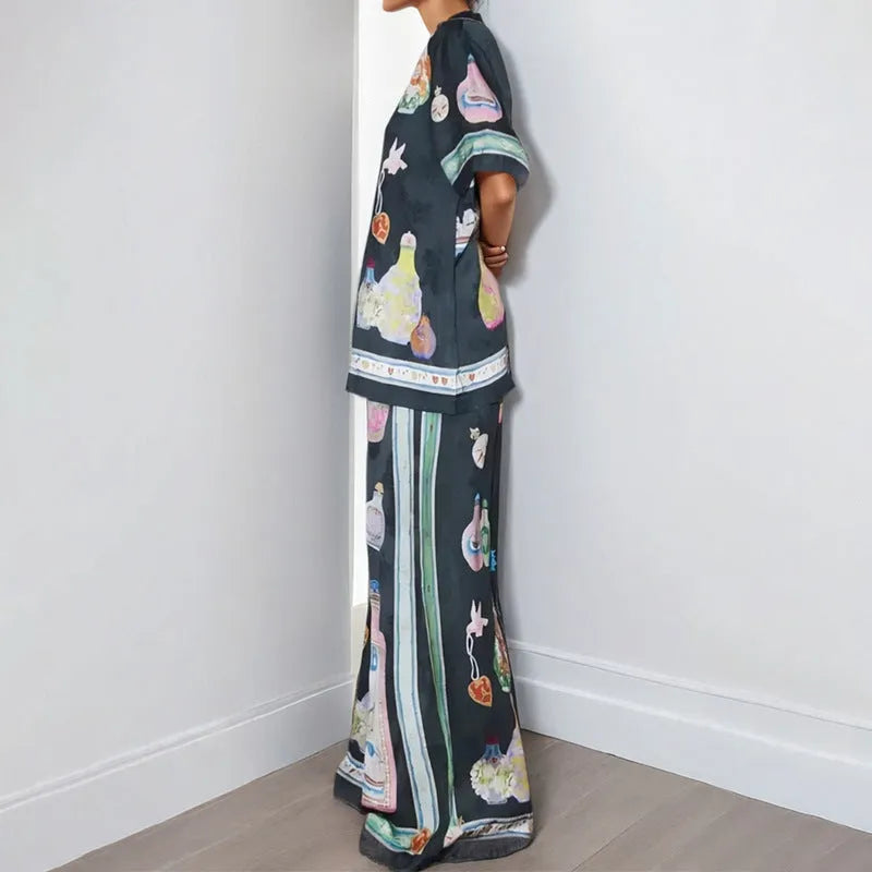 Black women's two-piece cardigan and trousers set with a cartoon animation pattern print.