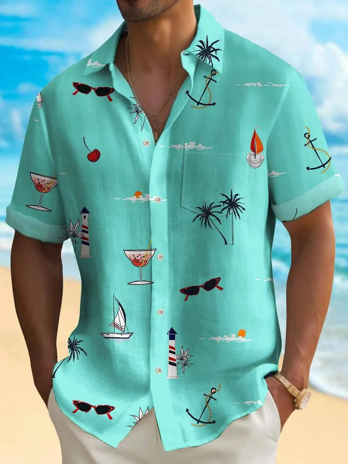 Man wearing a colourful loose-fit Hawaiian print short sleeve shirt on a beach.