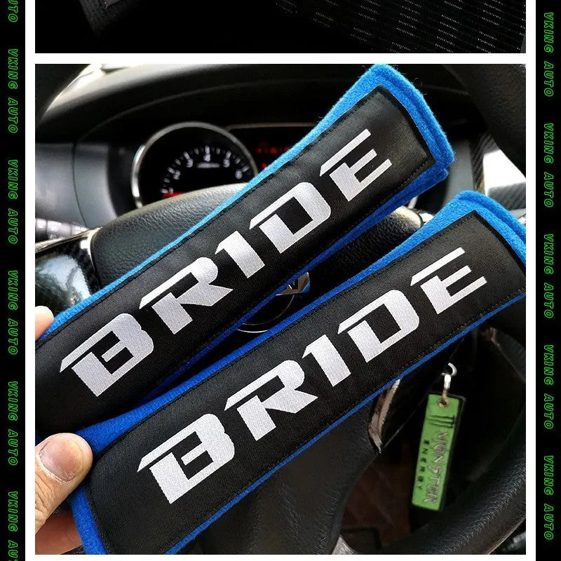 Car seat belt shoulder pad set in black, blue, or red colours with sponge padding and decorative embroidery