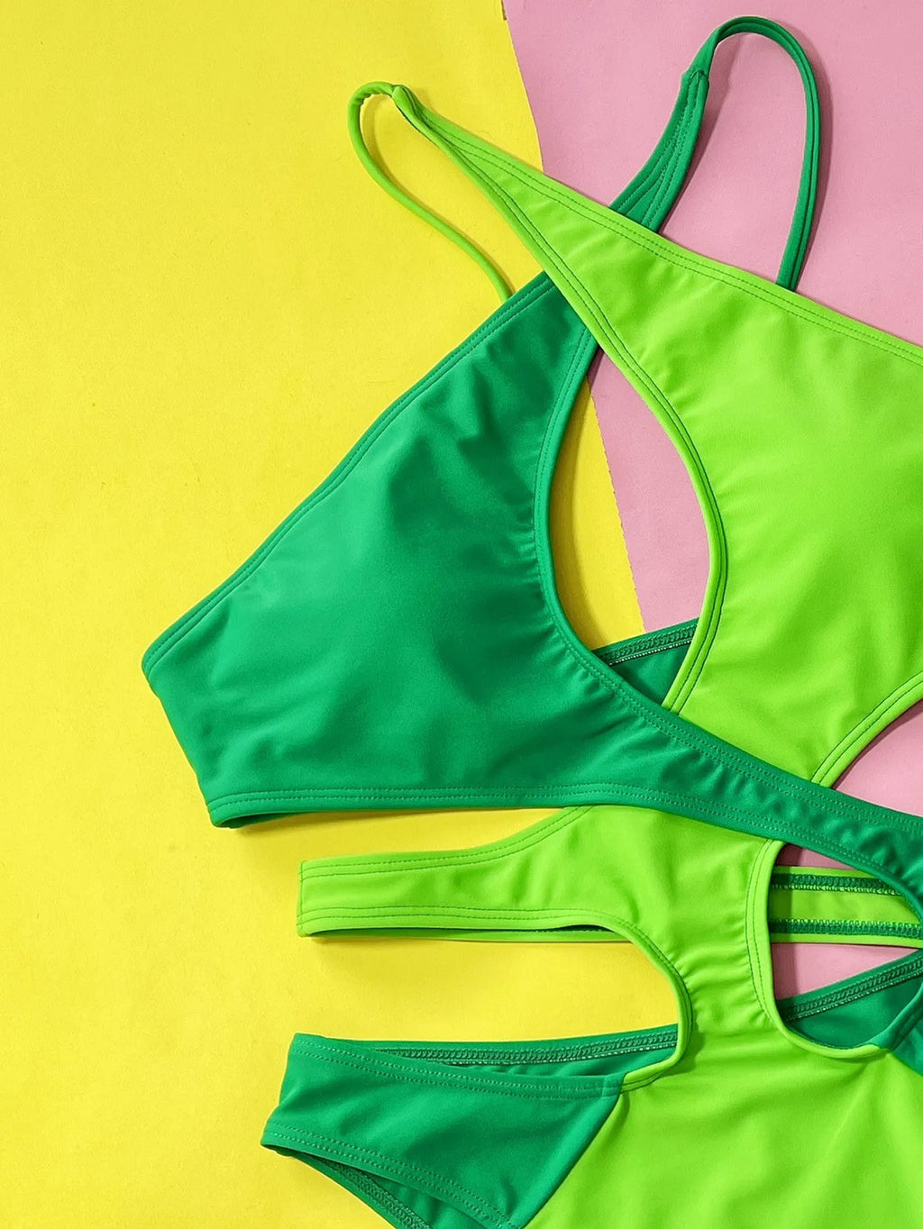 Green women's one-piece swimsuit with a hollow contrast colour design