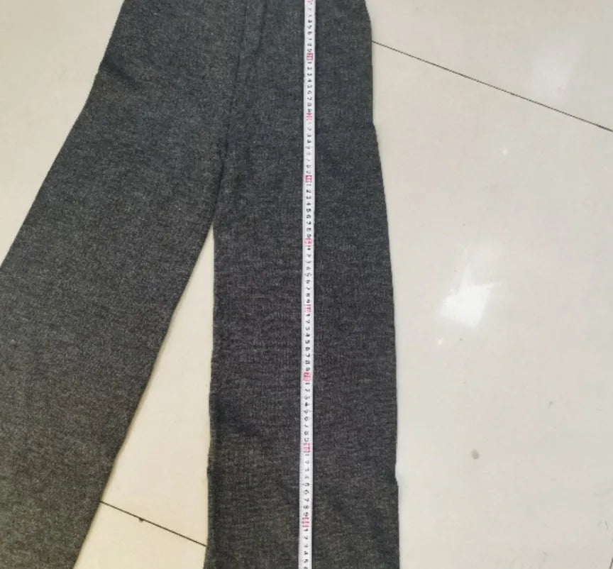 Women's knitted suit with side-slit sweater and matching trousers in acrylic fabric