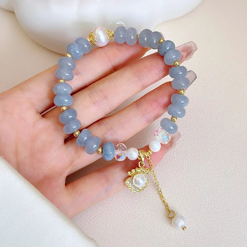 Handmade bracelet with a natural blue-green aquamarine pearl shell on an adjustable band.