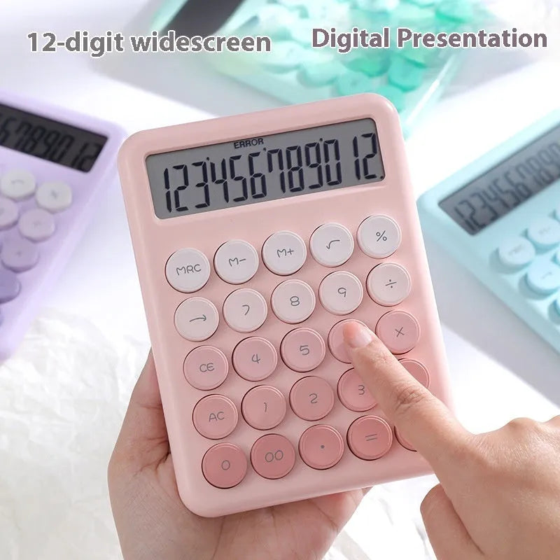 Gradient colour desktop calculator with large keys on a desk, shown in violet, pink, blue, and green colour options.