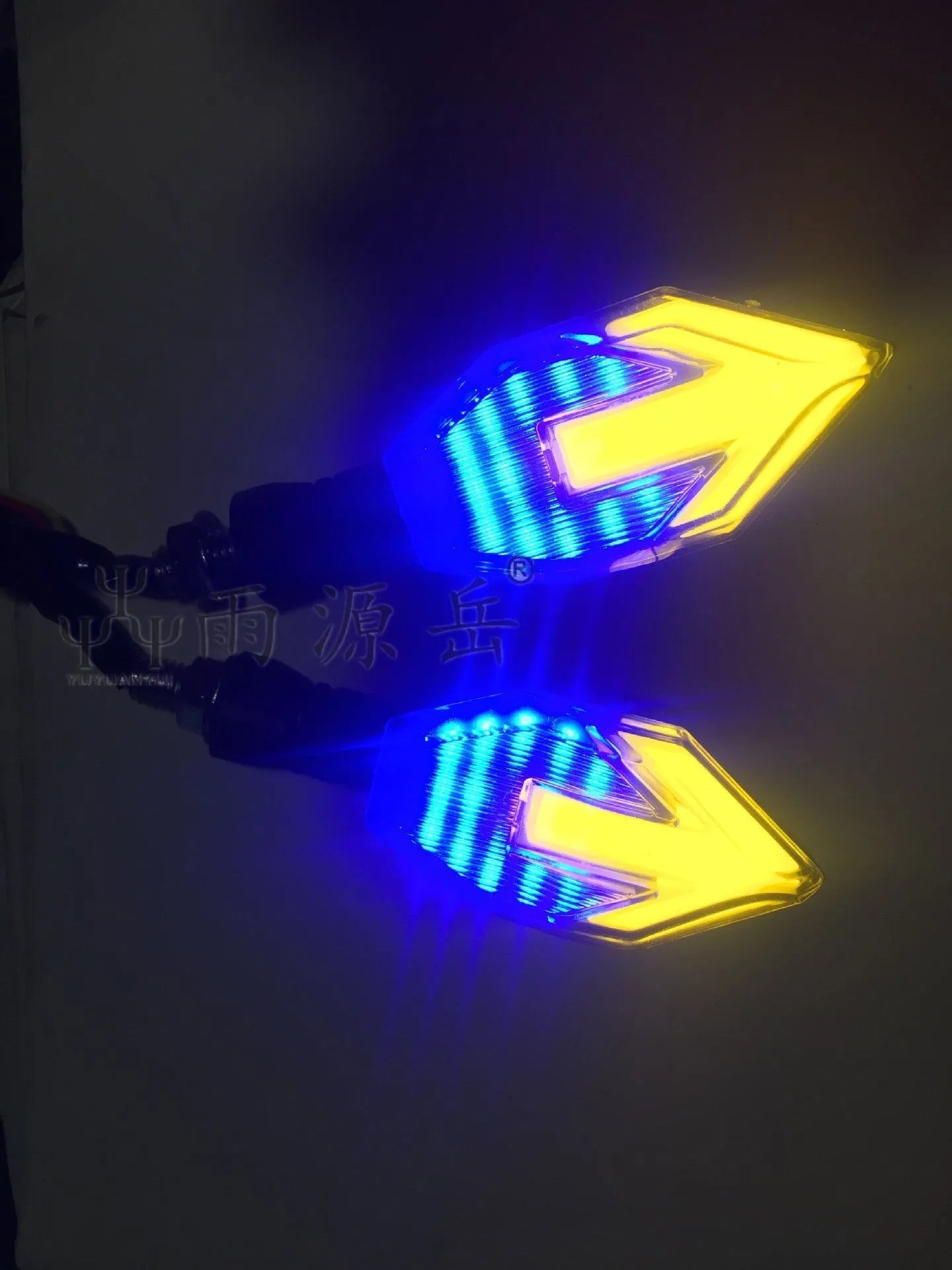 Arrow-shaped LED motorcycle turn signal indicator light with 12V connector.