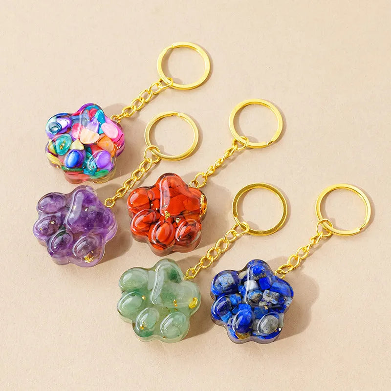 Natural crystal cat's paw keychain pendant on a keyring, colour varies by random gemstone type.