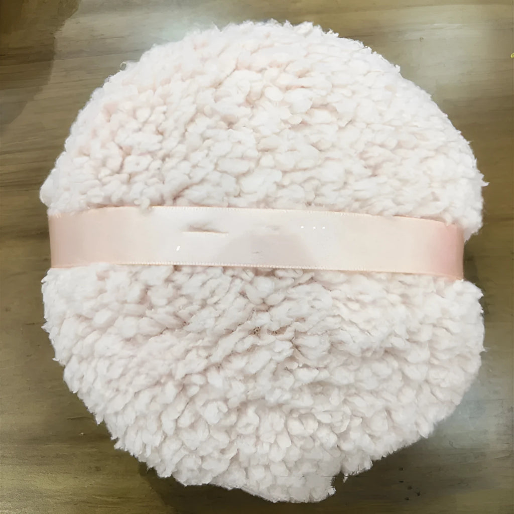 Oversized rectangular plush powder puff in pink, white, or skin colour for dry makeup application.