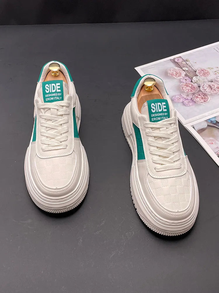 A pair of white and green casual shoes with a cloth upper and rubber foam sole, shown on a plain background.