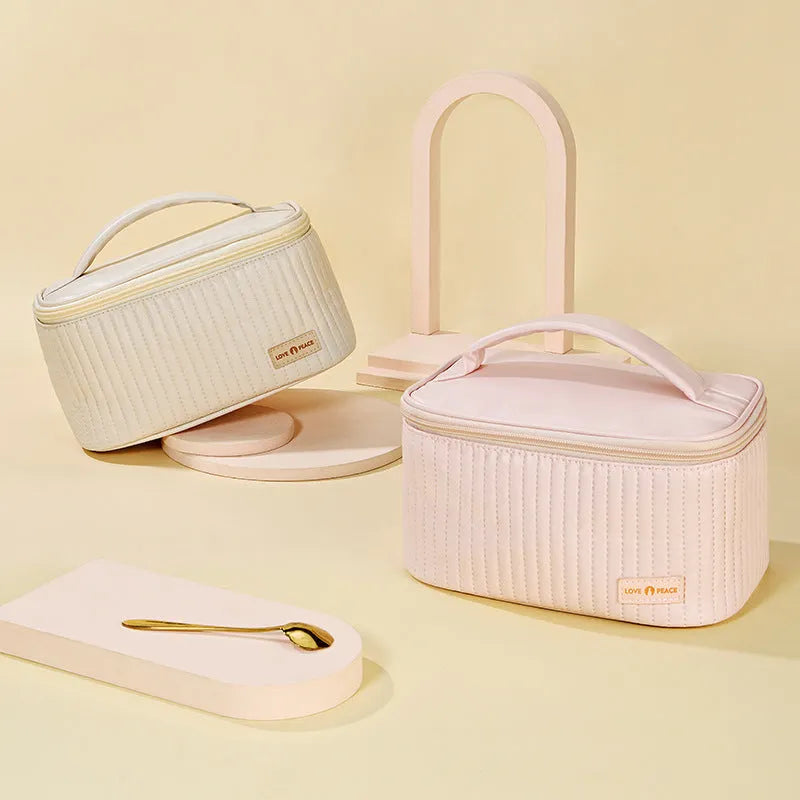 Open-top cake style makeup bag in PU leather, shown in beige, with dimensions 24cm by 16cm by 13cm.