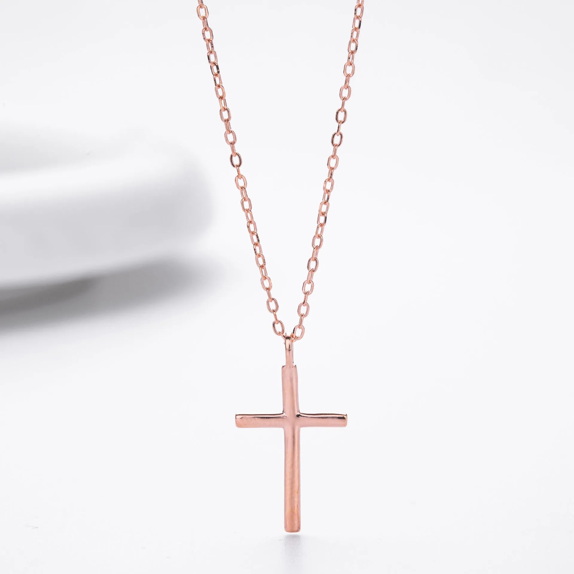 S925 sterling silver necklace with glossy cross pendant on an adjustable O-chain in gold, platinum, or rose gold finish.