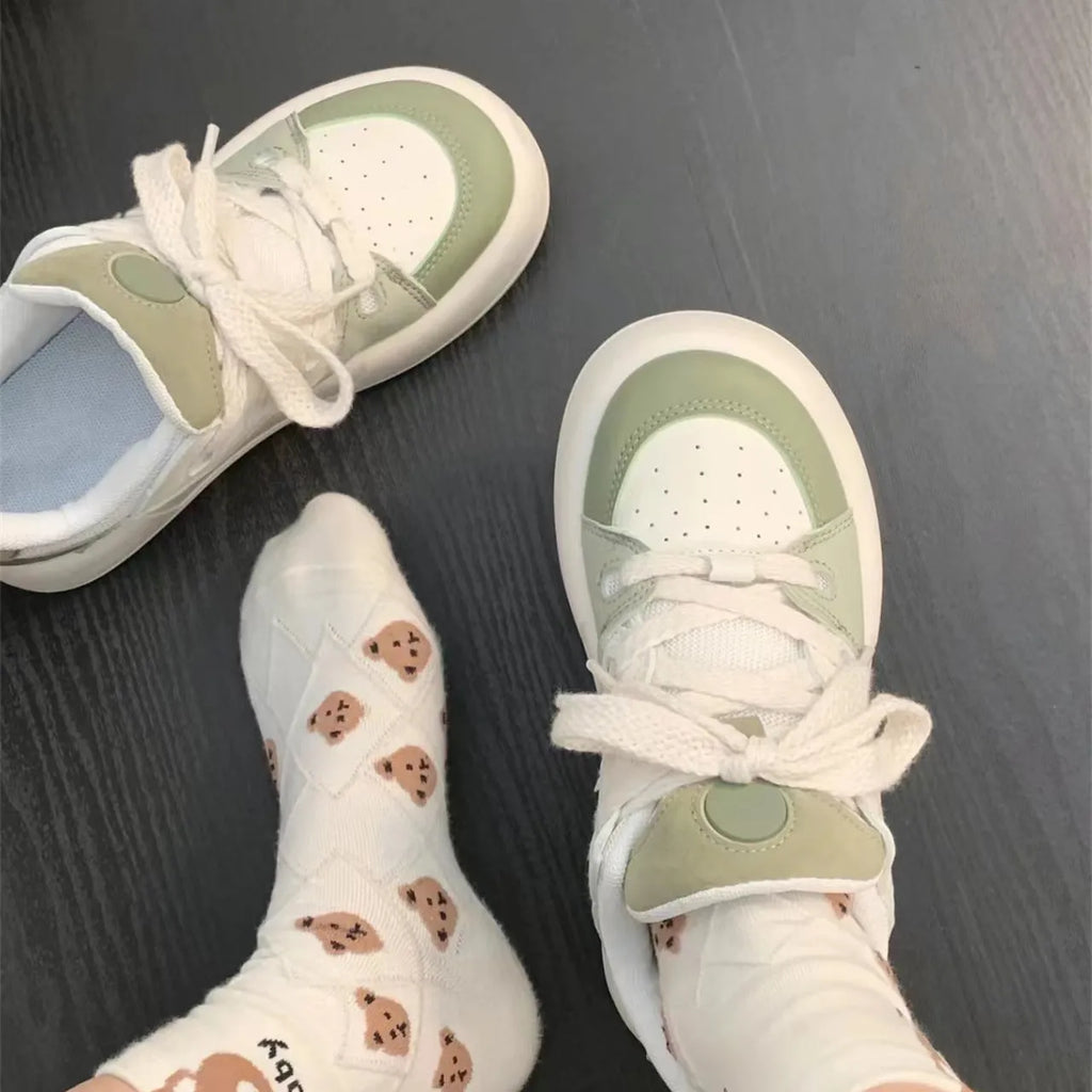 Green women's casual shoes with mesh upper, flat heel, and round toe design