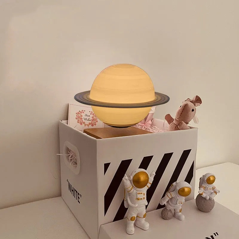 Maglev floating moon and planet night light with LED glow and small astronaut figures on base.