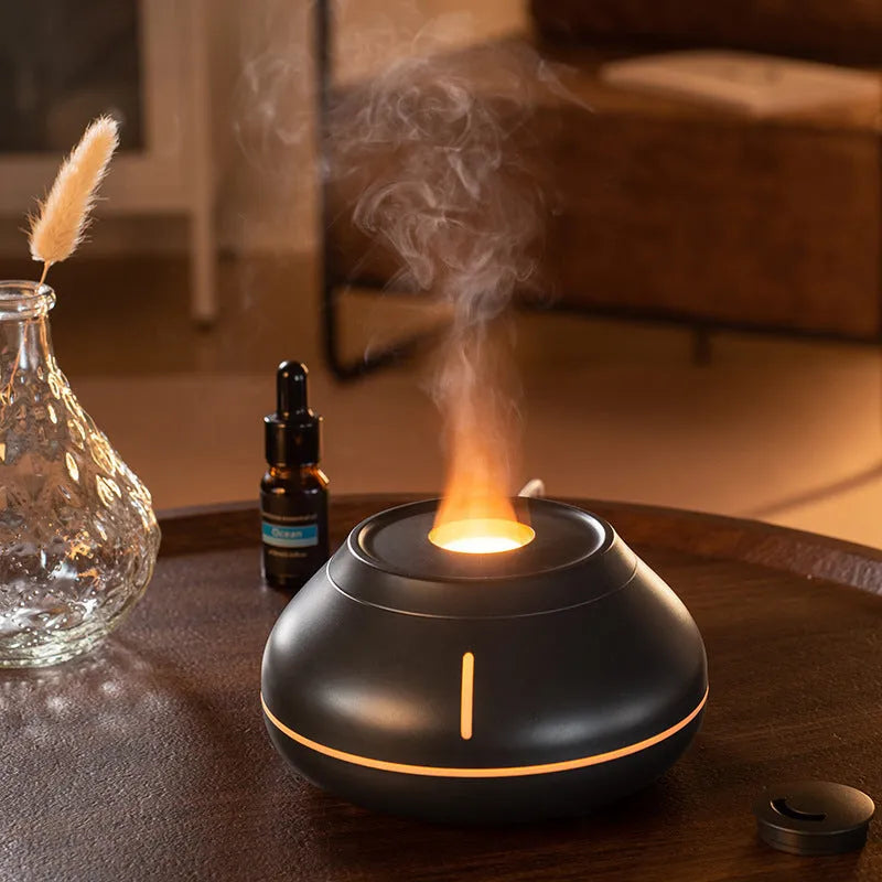 Round white flame effect aroma diffuser humidifier with colourful LED lighting on wooden desk