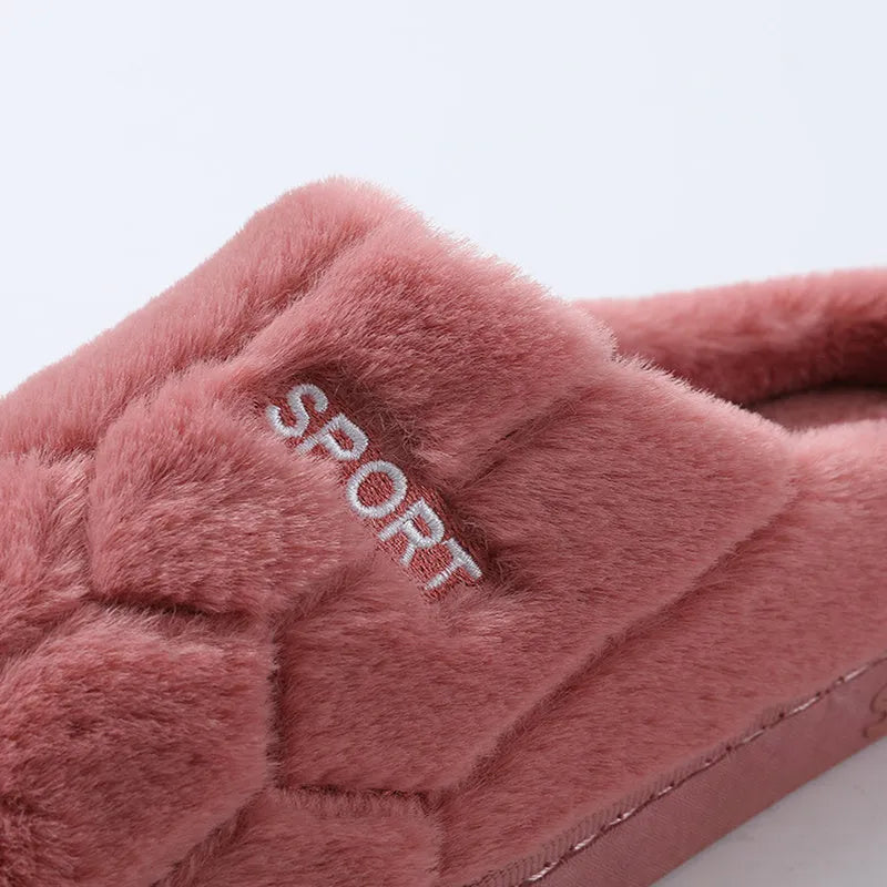 Unisex plush house slippers with white honeycomb-patterned PVC sole, showing round toe and plush inner lining in purple colour