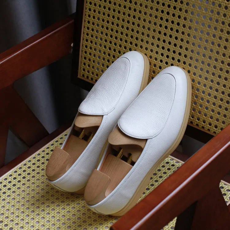 British handmade men's genuine leather loafers in various colours on a flat shoe sole.