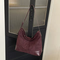 Women's PU leather retro shoulder crossbody bag in brown with ribbon pendant, horizontal shape, sandwich pocket