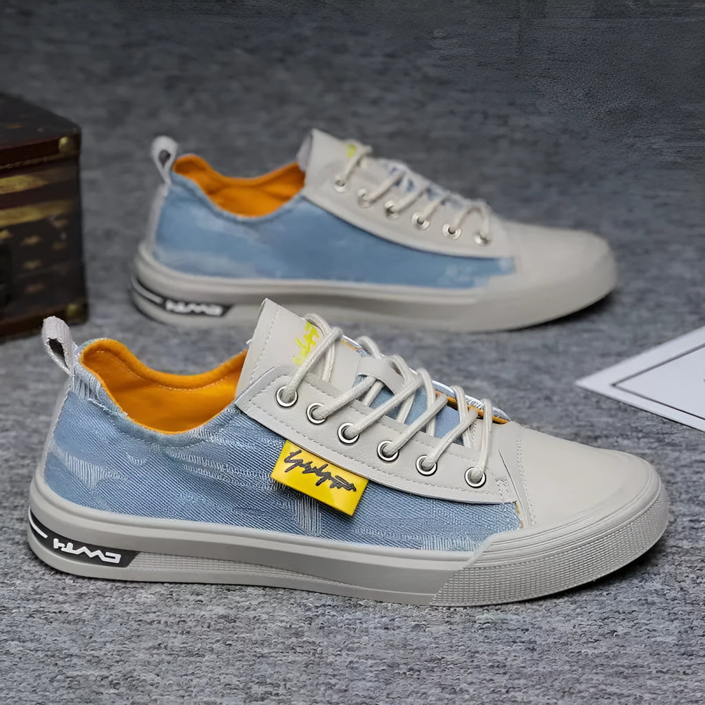Men's dark blue canvas lace-up shoes with a round toe and white rubber sole on a neutral background.